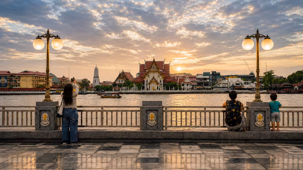 Bangkok riverside promenade facing local temple architecture at sunset